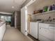 Bright laundry room featuring a washer, dryer and shelving for storage at 58 Basswood Cir # 29, Atlanta, GA 30328