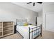 Cozy bedroom with carpet, neutral walls, large windows with blinds, ceiling fan, a metal bed frame, and a white door at 1430 Dresden Ne Dr # 215, Atlanta, GA 30319