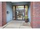 Building entrance with glass doors, brick columns, and exterior landscaping at 1430 Dresden Ne Dr # 215, Atlanta, GA 30319