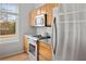 Close up view of modern kitchen with stainless steel refrigerator, gas range, microwave, wood cabinets, granite counters, and tile backsplash at 1430 Dresden Ne Dr # 215, Atlanta, GA 30319