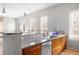 Modern kitchen with granite countertops, wood cabinets, stainless steel appliances and fixtures, and a breakfast bar with pendant lighting at 1430 Dresden Ne Dr # 215, Atlanta, GA 30319