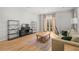 Bright living room with hardwood floors, sofa, area rug, large windows, french doors to balcony, neutral paint, and built-in shelves at 1430 Dresden Ne Dr # 215, Atlanta, GA 30319