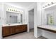 Bright bathroom featuring double sinks and a vanity area. A shower and toilet are visible in the mirror reflection at 165 River Ridge Ln, Roswell, GA 30075