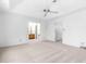 Spacious, carpeted bedroom with a ceiling fan and a view into the en suite bathroom and closet at 165 River Ridge Ln, Roswell, GA 30075
