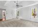 Spacious bedroom featuring a tray ceiling, plush carpeting, and windows that provide natural light at 165 River Ridge Ln, Roswell, GA 30075