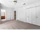 Spacious, carpeted bedroom with a ceiling fan, a view into the en suite bathroom, and a double closet at 165 River Ridge Ln, Roswell, GA 30075