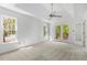 Bright bedroom features a tray ceiling, plush carpeting, and french doors to deck at 165 River Ridge Ln, Roswell, GA 30075