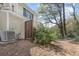 Exterior view of home showing fenced area, exterior AC unit and natural landscaping at 165 River Ridge Ln, Roswell, GA 30075