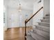 Inviting foyer with hardwood floors, staircase, and decorative glass windows by the door at 165 River Ridge Ln, Roswell, GA 30075