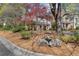 View of the home's front yard with mature trees and landscaping at 165 River Ridge Ln, Roswell, GA 30075