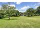 Large grass area with community building and various activities in the background at 165 River Ridge Ln, Roswell, GA 30075