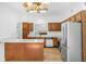 Functional kitchen featuring stainless steel appliances, wood cabinets, and a breakfast bar for casual dining at 165 River Ridge Ln, Roswell, GA 30075