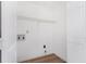Bright laundry room with wood floors, white walls, shelving and appliances hookups at 165 River Ridge Ln, Roswell, GA 30075