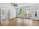 Bright living room with a ceiling fan, lots of natural light, and access to the back deck at 165 River Ridge Ln, Roswell, GA 30075