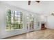Light-filled living room with large windows offering a view of the deck and brick fireplace, ideal for cozy gatherings at 165 River Ridge Ln, Roswell, GA 30075
