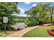 Riverfront and grassy area with a sign asking that visitors not feed the ducks and geese in a peaceful community at 165 River Ridge Ln, Roswell, GA 30075