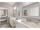 Bright bathroom with double sinks, tile floor, and a view into the attached bedroom at 2033 Lee Se Rd, Smyrna, GA 30080