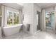 Modern bathroom featuring a standalone tub, glass shower, and elegant marble flooring at 2033 Lee Se Rd, Smyrna, GA 30080