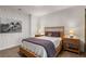 Comfortable bedroom with a patterned accent wall, a cozy bed, and wicker nightstands at 2033 Lee Se Rd, Smyrna, GA 30080