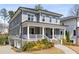 Beautiful home with a welcoming front porch, gray siding, white columns and finished basement at 2033 Lee Se Rd, Smyrna, GA 30080