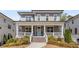 Charming two-story home featuring a welcoming front porch, beautiful gray siding and manicured landscaping at 2033 Lee Se Rd, Smyrna, GA 30080