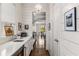 Hallway view with white horizontal shiplap, leading to the kitchen with bright lighting at 2033 Lee Se Rd, Smyrna, GA 30080