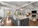 Open concept kitchen and living area with large kitchen island, white countertops and hardwood floors at 2033 Lee Se Rd, Smyrna, GA 30080