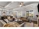 Open-concept living area featuring hardwood floors, a brick fireplace, and comfortable seating at 2033 Lee Se Rd, Smyrna, GA 30080