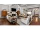 Cozy living room with neutral furniture, brick fireplace, stairs, and hardwood flooring at 2033 Lee Se Rd, Smyrna, GA 30080