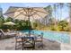 Inviting backyard pool with patio, lounge chairs, dining area, and lush landscaping for outdoor enjoyment at 2033 Lee Se Rd, Smyrna, GA 30080