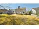 Large backyard with lush grass, mature trees, and a wooden deck, ideal for outdoor activities at 3185 Haverhill Rowe, Lawrenceville, GA 30044