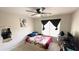Cozy bedroom featuring a ceiling fan, natural light, and a comfortable bed with patterned coverlet at 3185 Haverhill Rowe, Lawrenceville, GA 30044