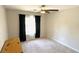 Clean bedroom with plush carpeting, a modern ceiling fan, and a large window at 3185 Haverhill Rowe, Lawrenceville, GA 30044