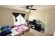 Comfortable bedroom featuring a ceiling fan, a flat screen TV, and a window letting in natural light at 3185 Haverhill Rowe, Lawrenceville, GA 30044