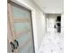 Hallway view featuring a sliding barn door with frosted glass panes at 3185 Haverhill Rowe, Lawrenceville, GA 30044