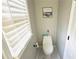 Clean and simple powder room with a toilet, window, and neutral walls at 3185 Haverhill Rowe, Lawrenceville, GA 30044