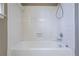Full white tile tub and shower combination in a bathroom at 2072 Arbor Forest Sw Dr, Marietta, GA 30064
