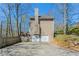 Rear view of the home featuring a two-car garage and wood siding at 2072 Arbor Forest Sw Dr, Marietta, GA 30064