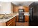 Functional kitchen featuring wooden cabinets, granite countertops, and modern black appliances at 2072 Arbor Forest Sw Dr, Marietta, GA 30064