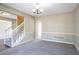 Open living room featuring neutral paint, carpet floors, base molding and a staircase at 2072 Arbor Forest Sw Dr, Marietta, GA 30064