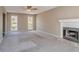 Spacious living room featuring a fireplace, neutral walls, plush carpet, and ample natural light from large windows at 2072 Arbor Forest Sw Dr, Marietta, GA 30064