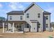 Rear exterior featuring a covered patio with outdoor seating and a spacious yard, ideal for relaxation at 469 Ralph Still Rd, Dacula, GA 30019