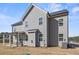 Exterior of the house with covered patio, dining set, and spacious yard, perfect for outdoor enjoyment at 469 Ralph Still Rd, Dacula, GA 30019