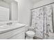 Clean bathroom featuring a single vanity, toilet, and shower with a unique curtain at 469 Ralph Still Rd, Dacula, GA 30019