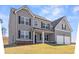 Attractive two-story house boasts neutral siding, balanced windows with shutters, and a charming front porch at 469 Ralph Still Rd, Dacula, GA 30019