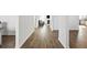 Bright hallway featuring hardwood floors leading to a living area and kitchen, showcasing the home's open layout at 469 Ralph Still Rd, Dacula, GA 30019