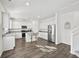 Bright and modern kitchen with white cabinets, granite countertops, stainless steel appliances, and a center island at 469 Ralph Still Rd, Dacula, GA 30019