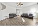 Expansive living room featuring stylish seating, a glass coffee table, and hardwood floors for a modern look at 469 Ralph Still Rd, Dacula, GA 30019