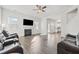 Spacious living area with hardwood floors, a fireplace, and a view into the kitchen, perfect for entertaining at 469 Ralph Still Rd, Dacula, GA 30019