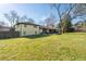 Grassy backyard view of home with patio at 399 W Sandtown Sw Rd, Marietta, GA 30064